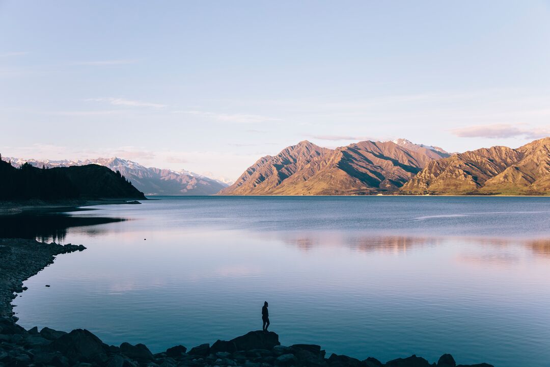 Person looking over Lake Hawea at dusk